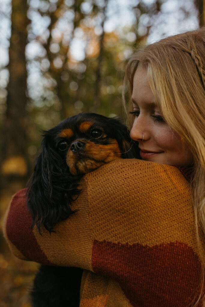 Savannah holding her dog, Korra, for her senior photos