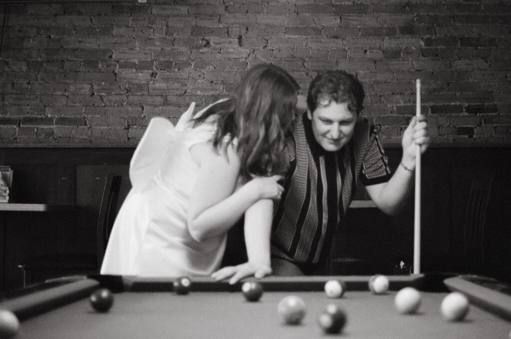 Minnesota Engagement Photos at bar and couple is playing pool