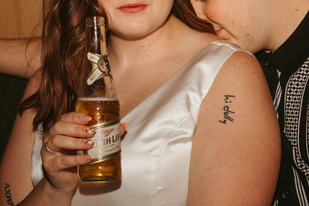 close up of couple with a miller high life at their Minneapolis Engagement Photos