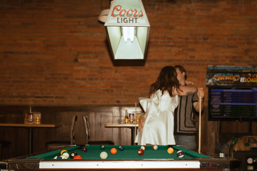 couple playing pool at their Minneapolis Engagement session