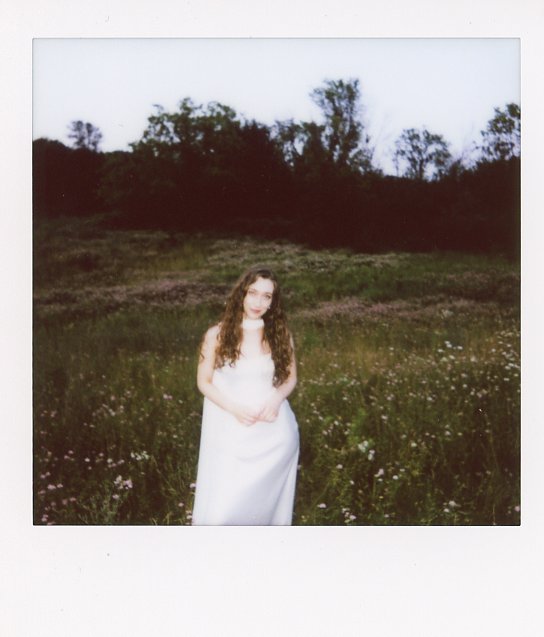 instant film shot of a woman in a white dress during a Minnesota elopement inspired anniversary photoshoot 
