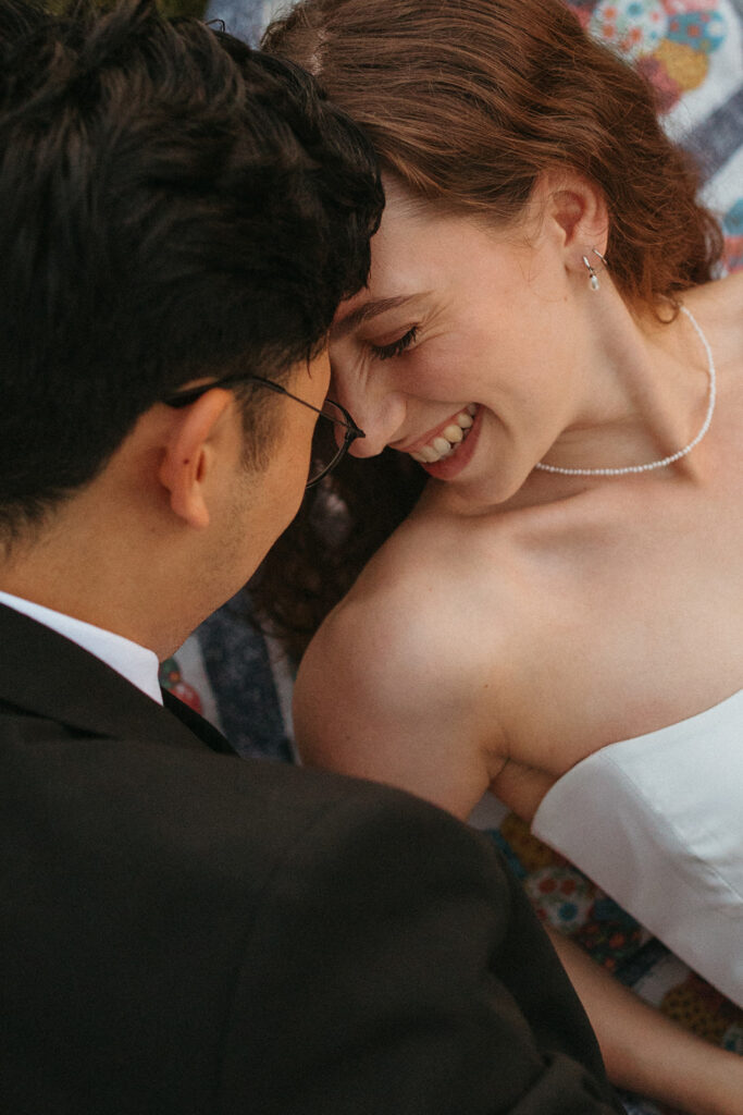 a couple smiles and embraces as they celebrate their 1 year minnesota elopement anniversary 