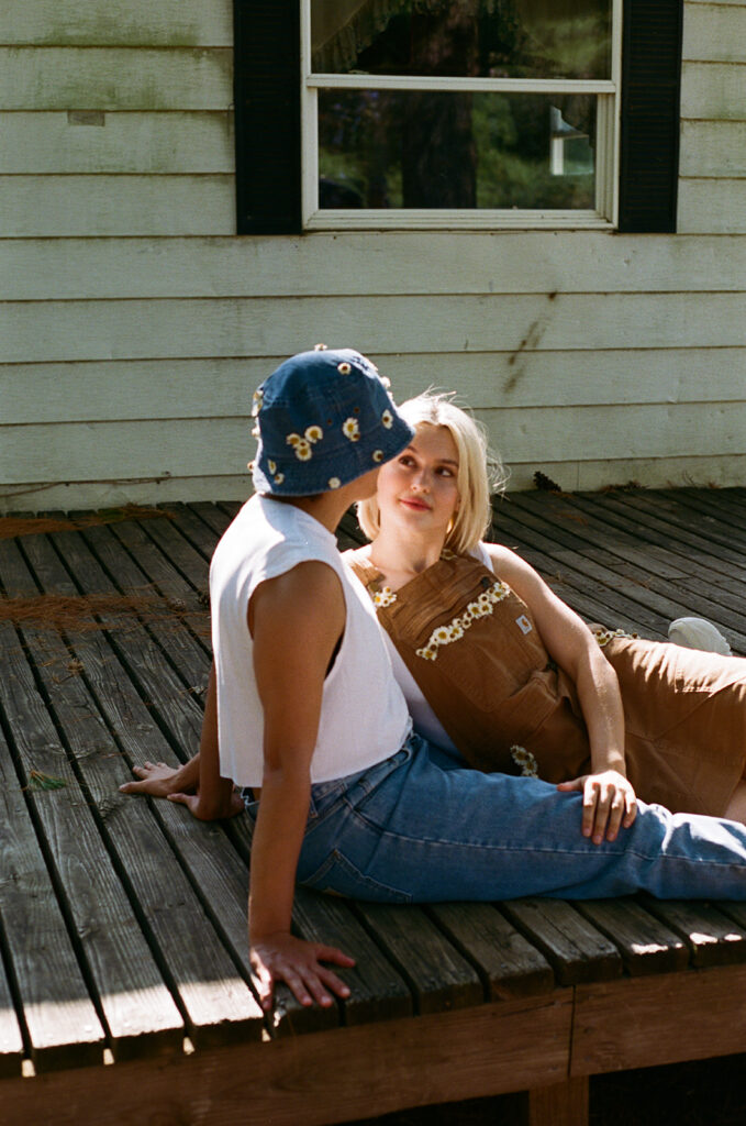 A couple is seated on a porch in a photo taken by a Twin Cities couples photographer
