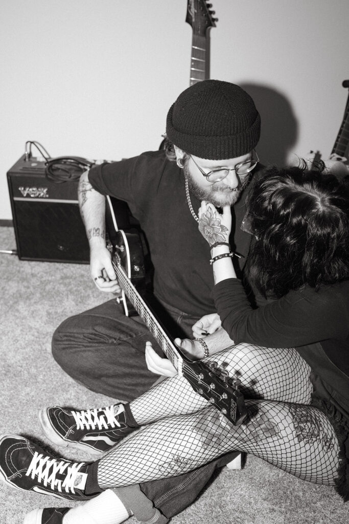 A black and white image of a young couple in their home during engagement photos in Milwaukee. 