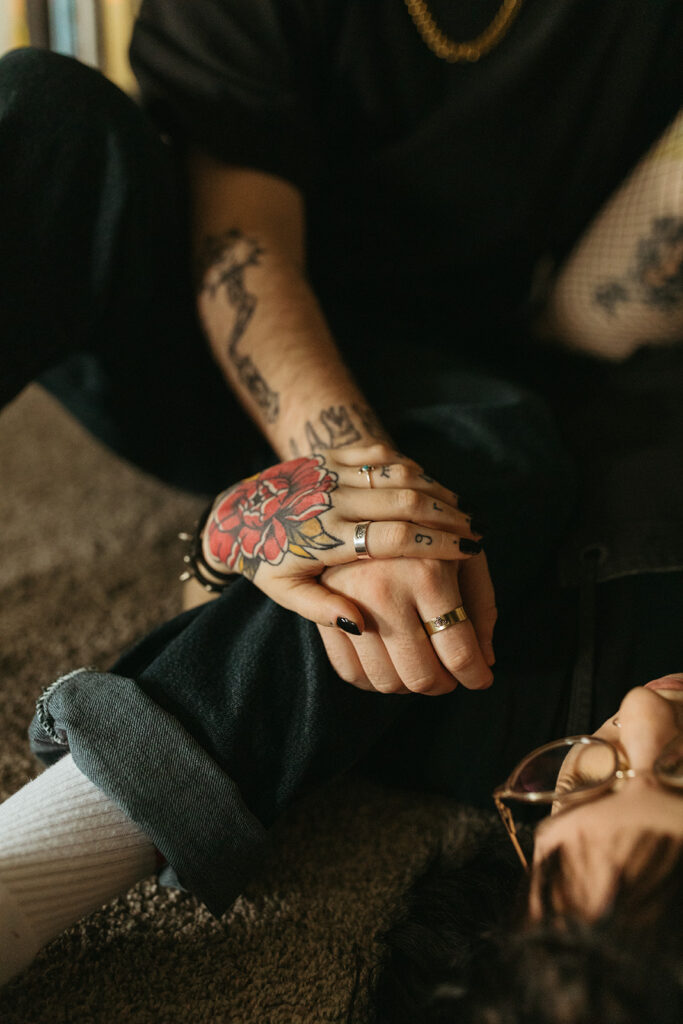 A close-up of a young couple holding hands during engagement photos milwaukee wi. 