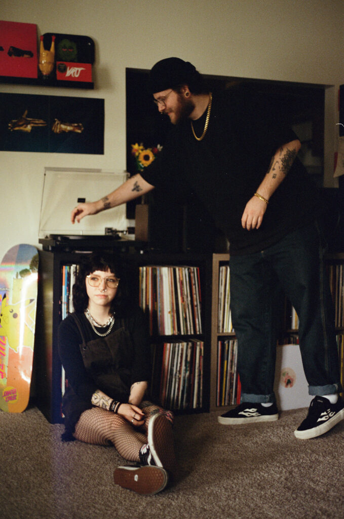 A film photo of an engaged couple taken in their living room during in-home engagement photos with a Wisconsin photographer for couples. 