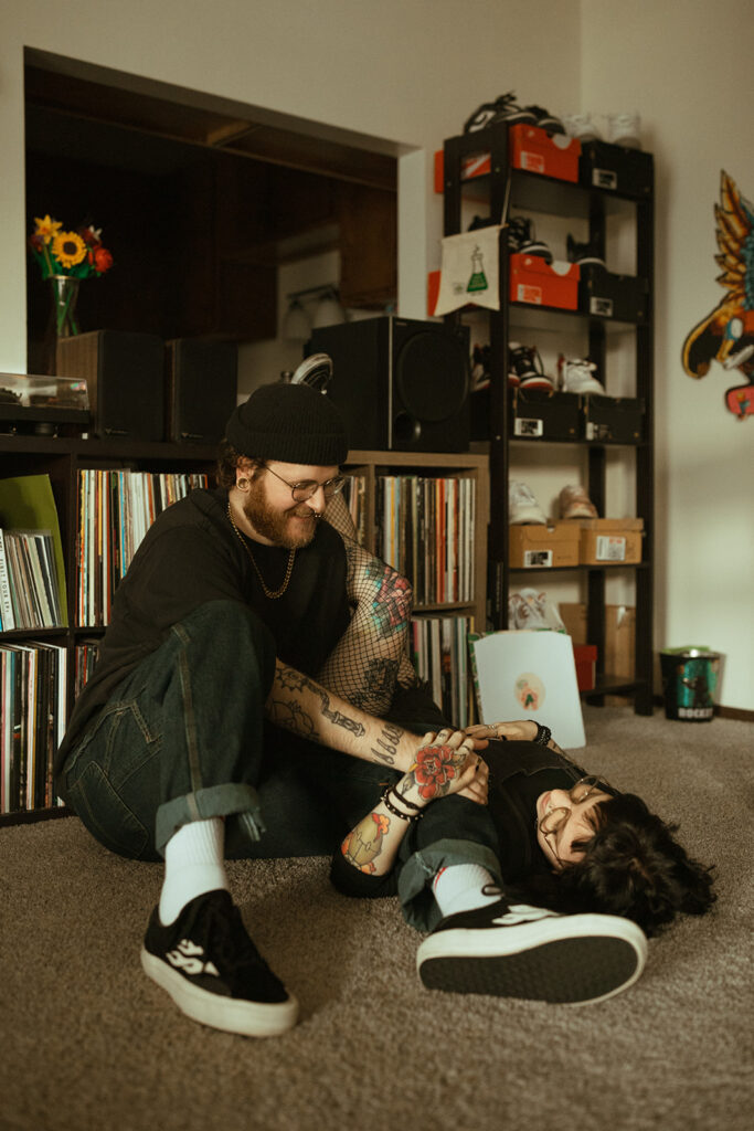 A young couple is photographed in their living room during an in-home engagement photoshoot with a Wisconsin photographer.