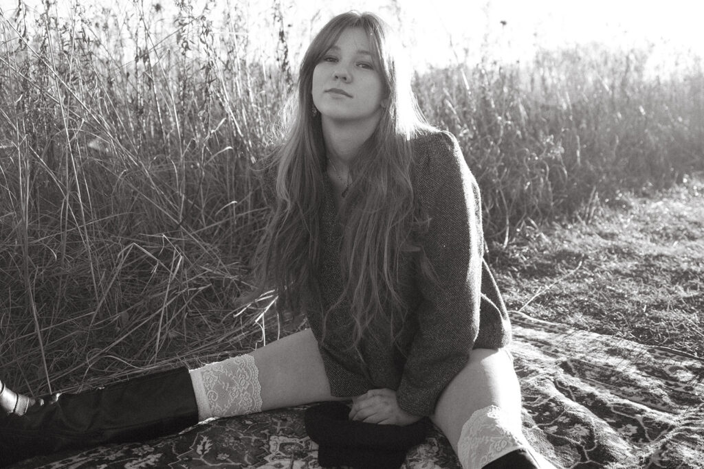 A black and white portrait of a high school senior taken during a vintage-inspired creative senior photoshoot at Afton State Park Minnesota