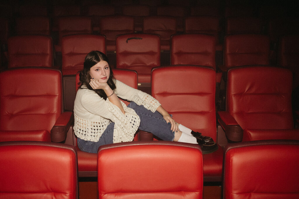 A film photo captures a Minneapolis senior at The Heights Theater during a session with a Minnesota senior photographer.